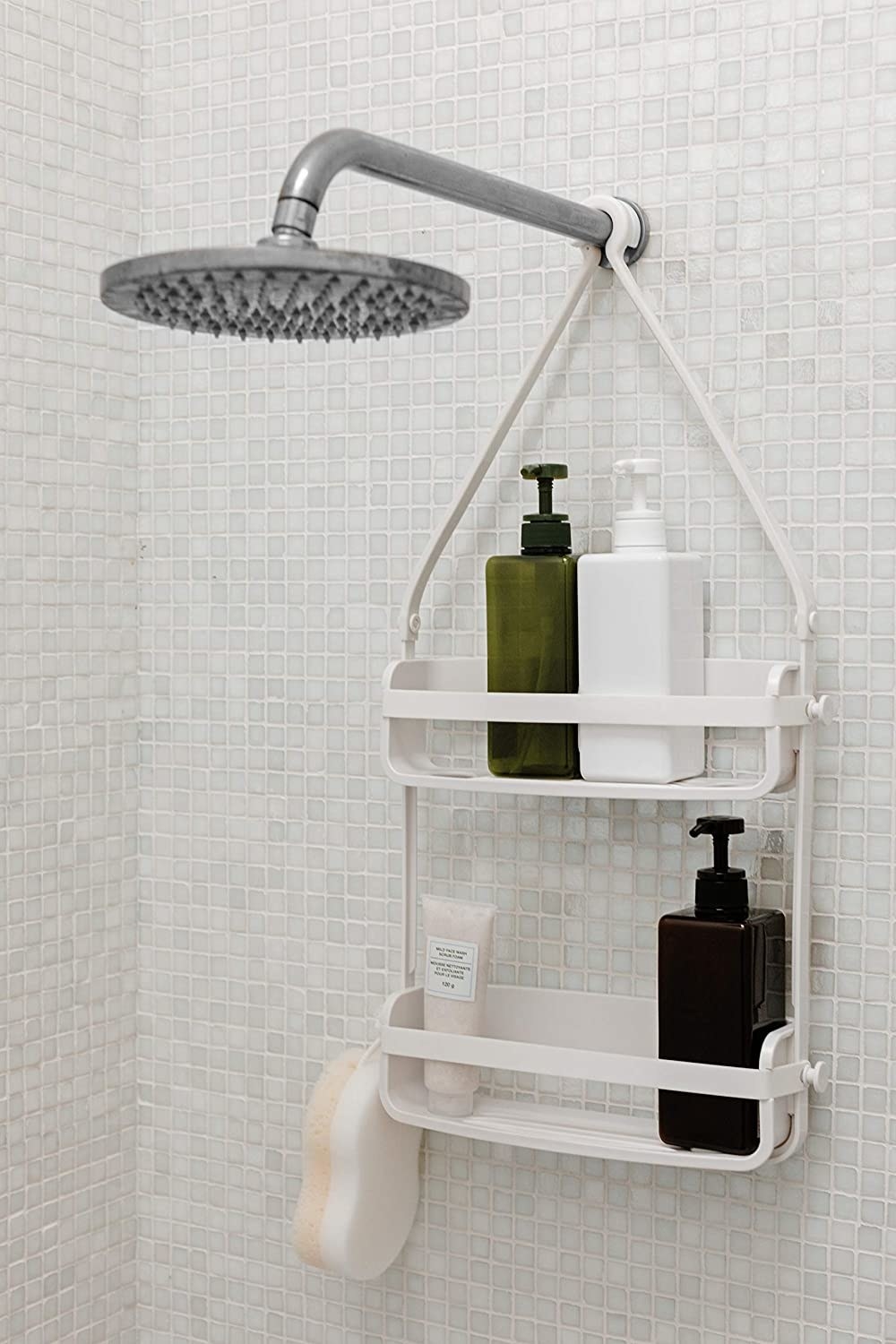 A two tiered shower caddy hanging from a shower hose