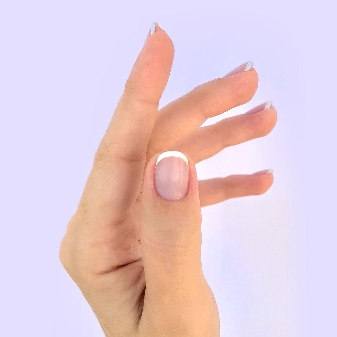 Closeup of a hand with a French manicure
