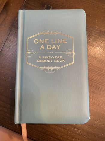 The cover of the small pale blue notebook