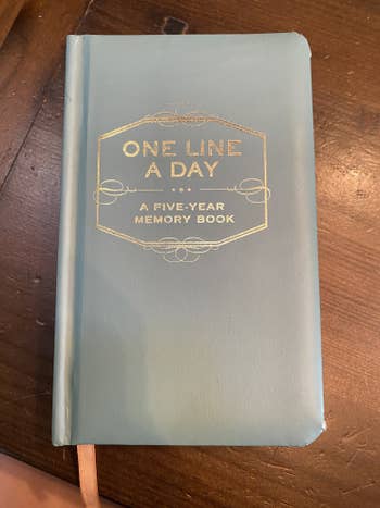 The cover of the small pale blue notebook 