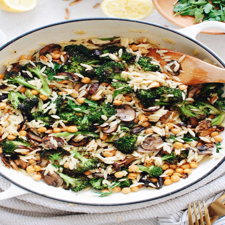 A big bowl of orzo with roasted broccoli, mushrooms, and chickpeas.