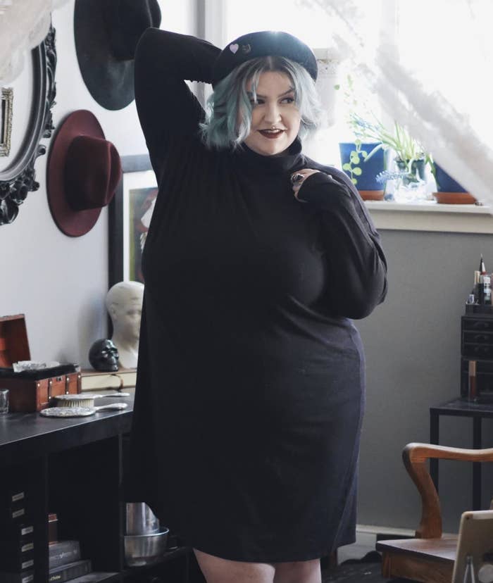reviewer wearing black sleeved dress