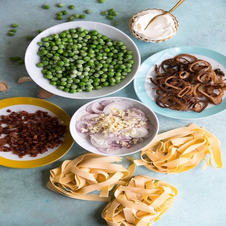 Pasta ingredients including pappardelle, peas, prosciutto, shallots, and garlic.