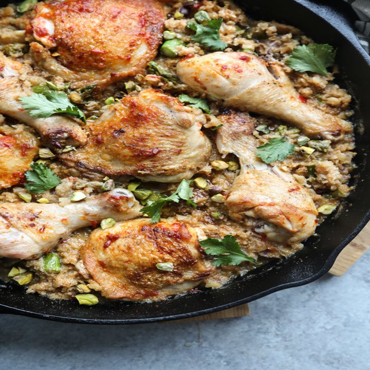 Crispy chicken thighs and drumsticks over cauliflower couscous with pistachios, dates, and herbs.