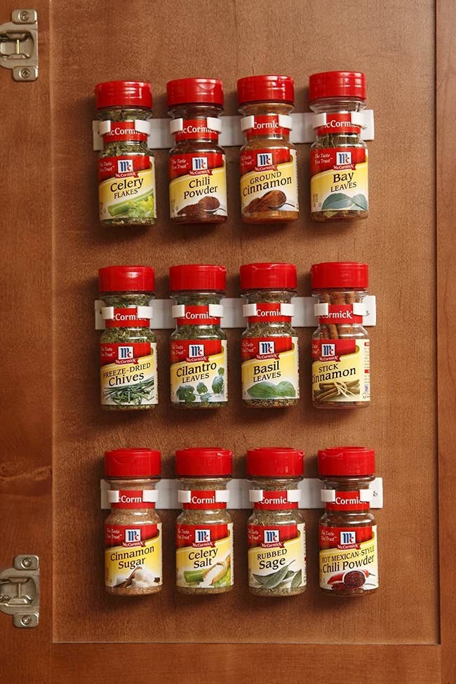 The product being used to organize spices on a cabinet door