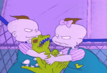 Phil and Lil fighting over Reptar toy