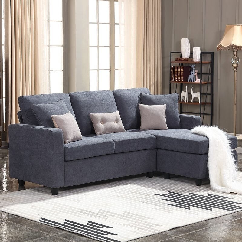 A three seater sofa with chaise in a bluish-gray upholstery