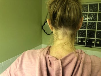 Reviewer pic showing their messy bun with flyaways in the back 