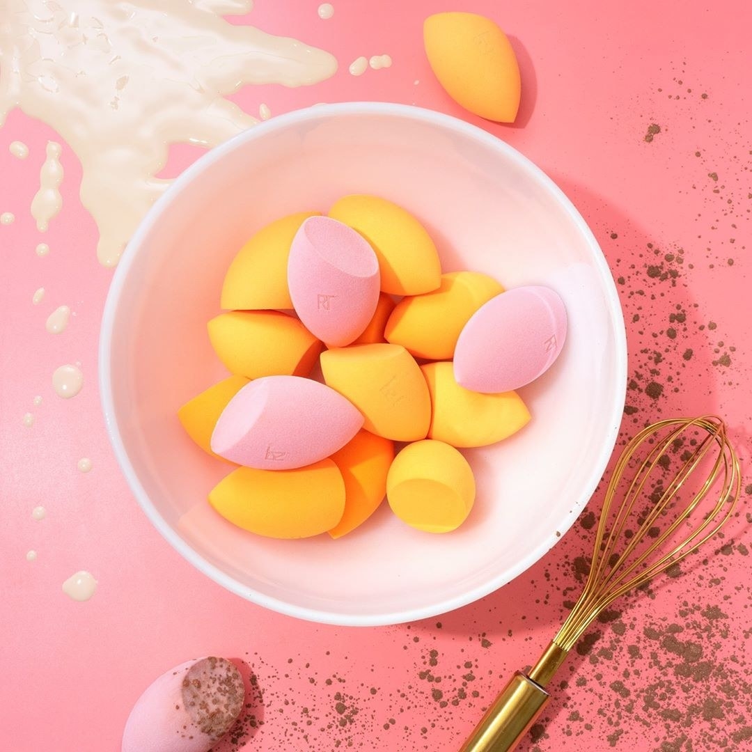 Bowl filled with pink and orange makeup sponges