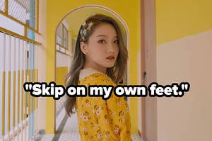 Gowon from Loona looks into the camera with the english lyrics skip on my own feet written below her face