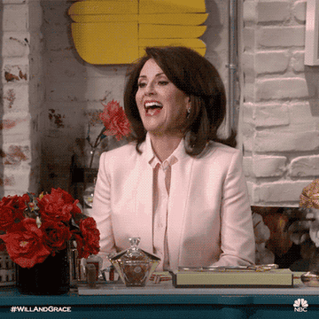 Karen from Will and Grace clapping excitedly 
