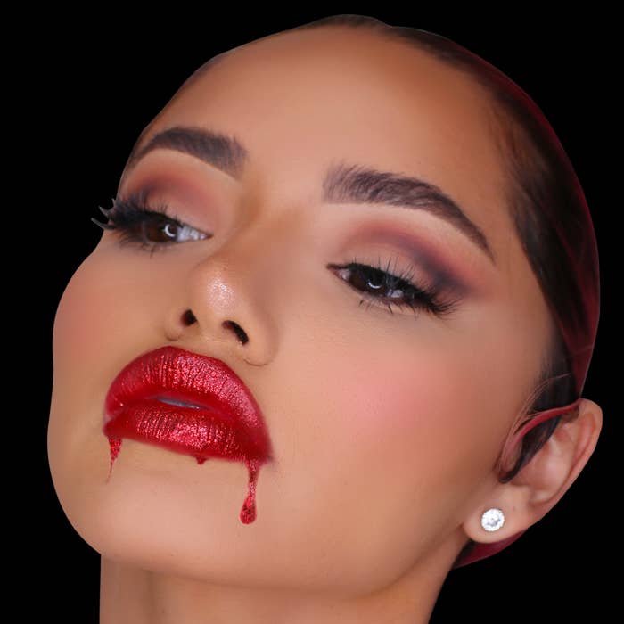Model wearing dripping glittery red lips