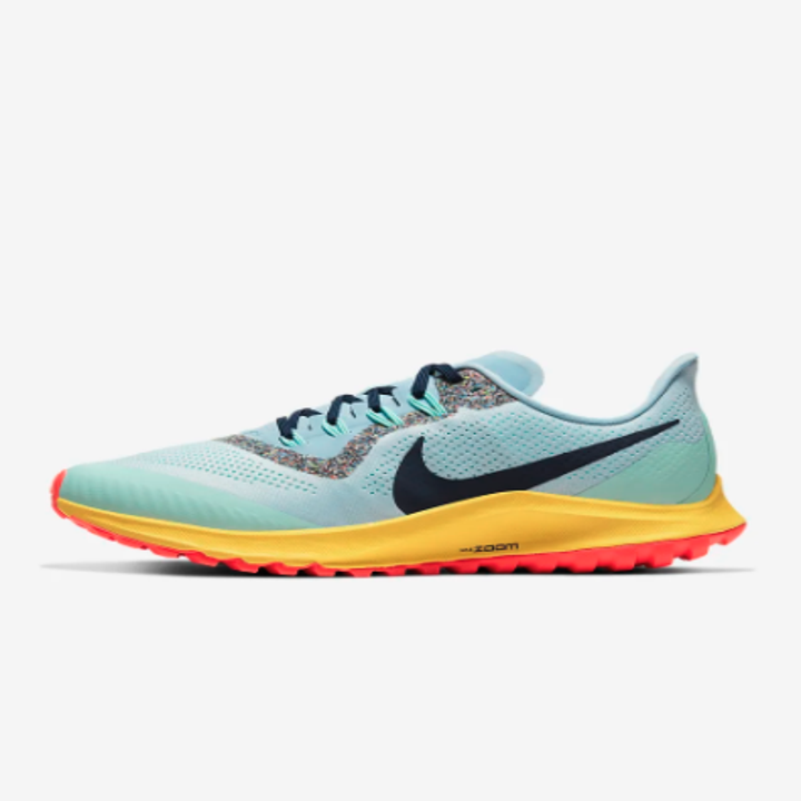 The shoes in teal and navy blue, with orange and yellow soles