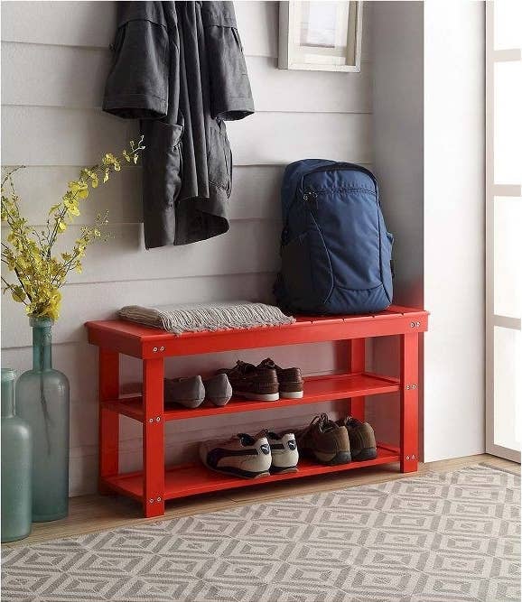 The red Oxford Utility Mudroom Bench storing shoes in an entryway