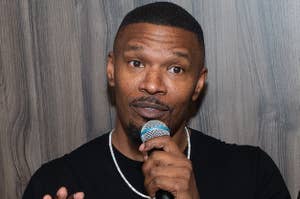 Jamie Foxx looks shocked holding a microphone