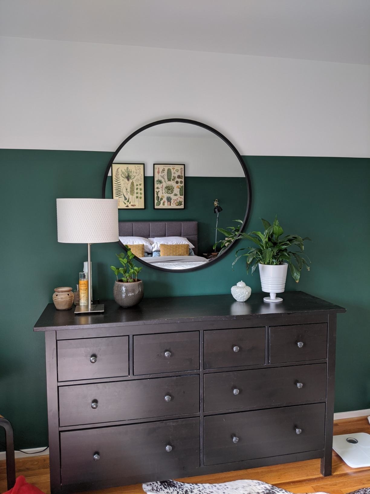A different reviewer with the mirror above a dresser, reflecting a bed in it