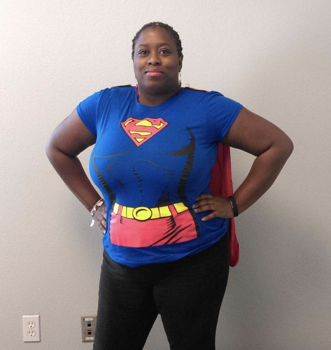 reviewer wearing blue and red tee with cape