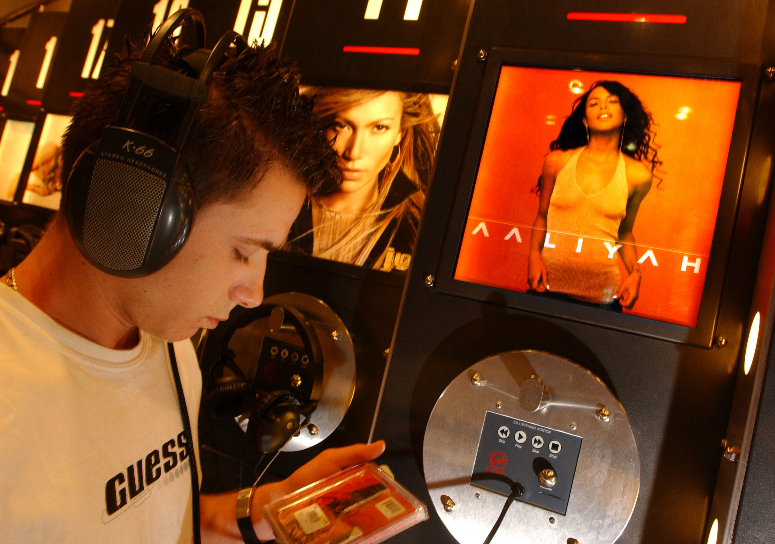 A man listening to Aaliyah&#x27;s &quot;Aaliyah&quot; album at the kiosk at a Virgin Megastore