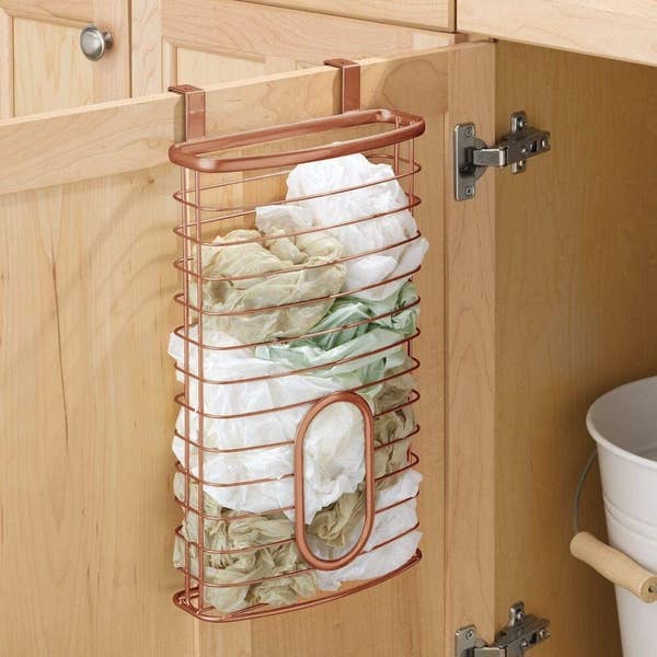 The copper plastic bag organizer hanging on a kitchen cabinet