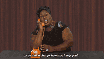 A GIF of Latrice Royale in RuPaul&#x27;s Drag Race skit saying &quot;Large and in charge, how may I help you?&quot;