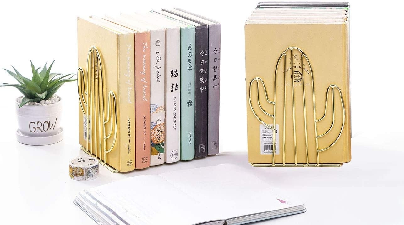 The Agirlgle Bookends Metal Book Ends holding up two stacks of books