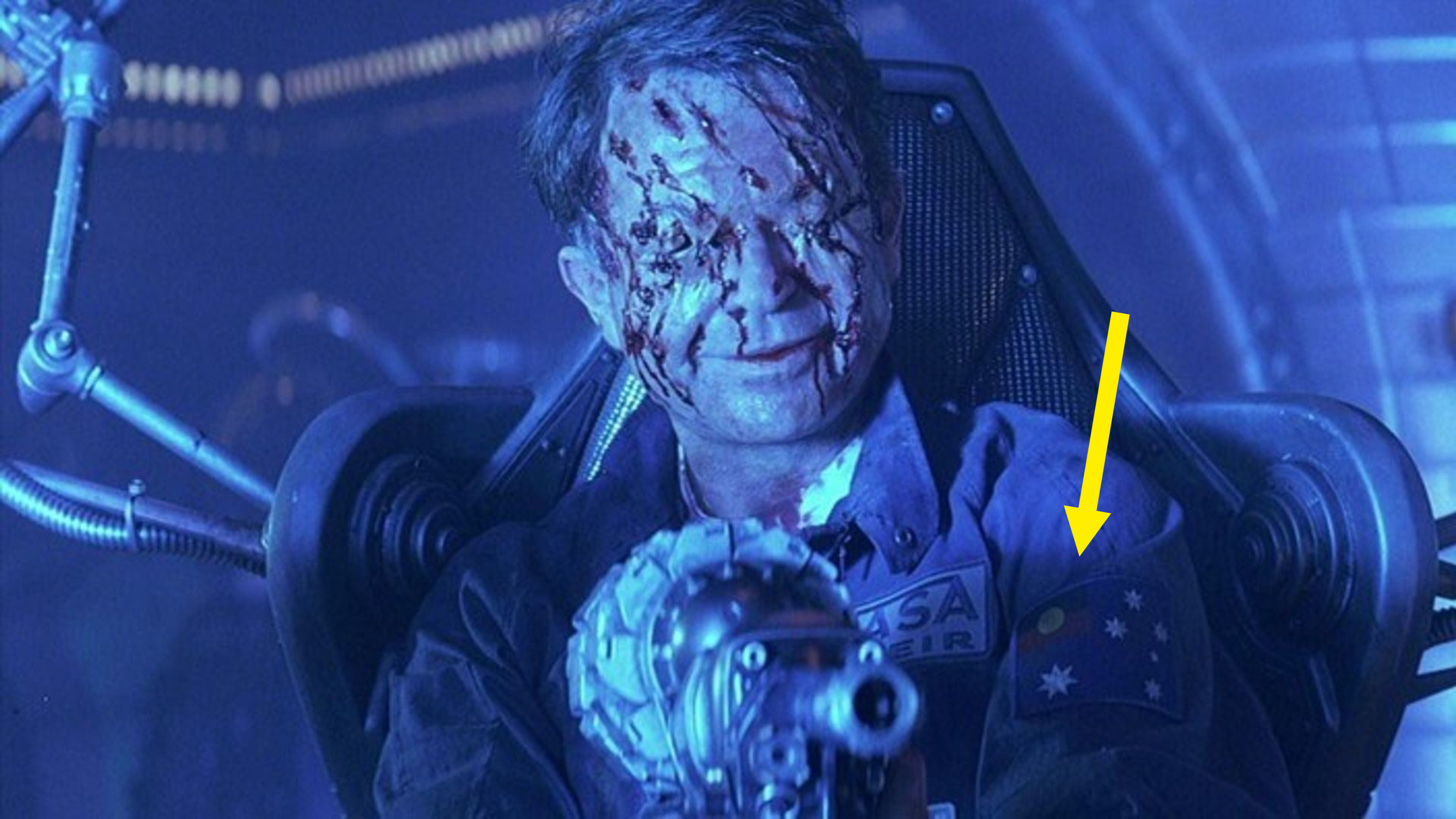 Sam Neill&#x27;s character in &quot;Event Horizon&quot; holding a gun. You can see the Aboriginal flag on his uniform