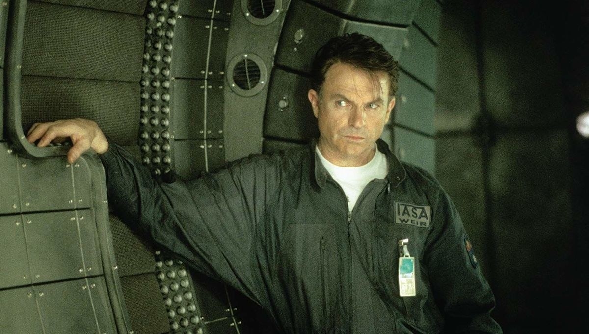 Sam Neill&#x27;s character in &quot;Event Horizon&quot; leaning against the interior of a spaceship 