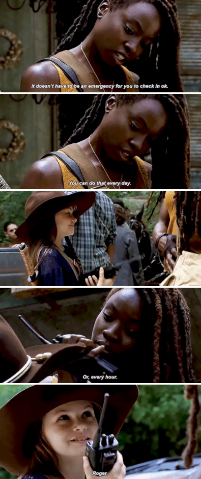 Michonne giving a young girl a walkie talkie, telling her she can talk to her anytime