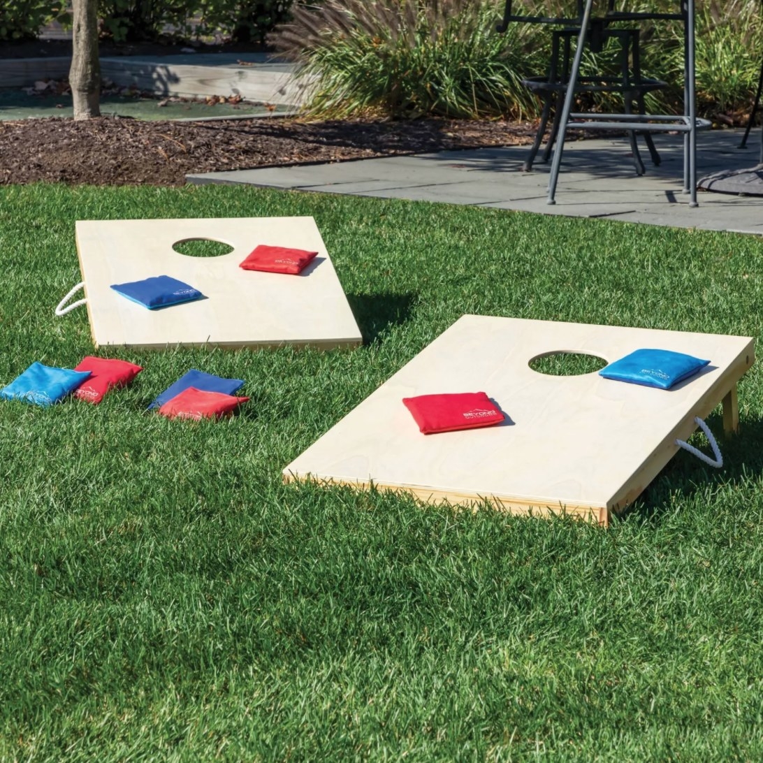 A wooden game with holes and small bean bags