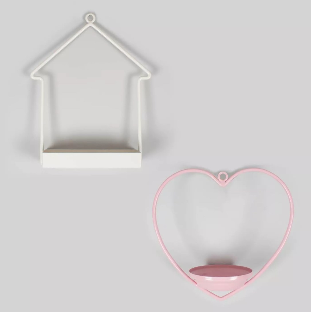 White and pink bird feeders in the shapes of a house and heart