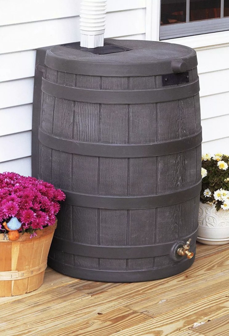 A gray barrel that&#x27;s used to collect rain water