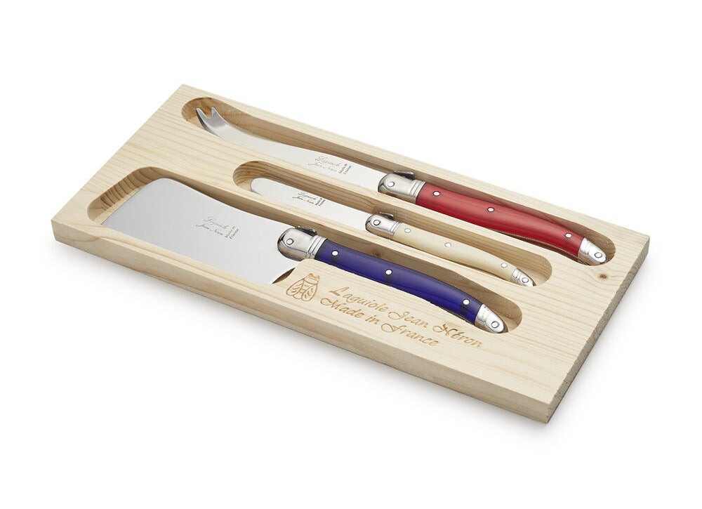The knife set with a spreader, a spade, and fork-tipped spear inside a storage box