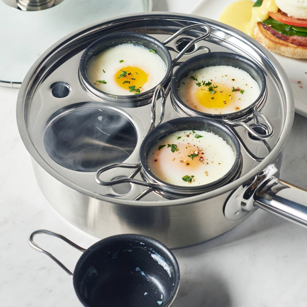 A pot with inserts and poached eggs inside