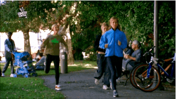 Lisa Kudrow in the TV show &quot;Friends&quot; running with her arms flailing past other people