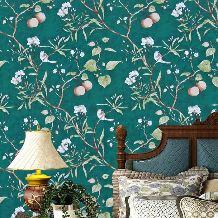 The dark emerald green wallpaper with white and pink floral and leaf designs