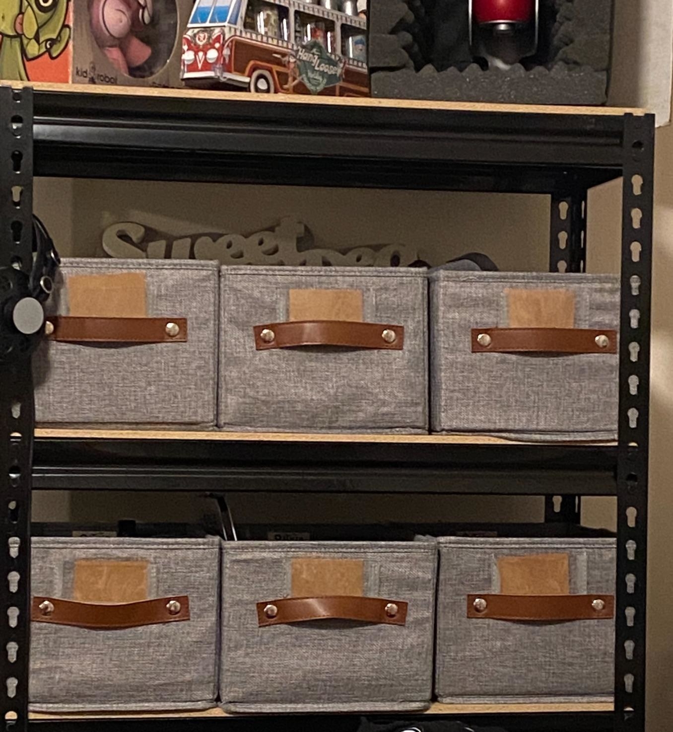 A reviewer showing six cube-shaped tote baskets on their shelves