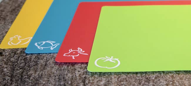 Yellow, blue, red, and green mats with different food labels 