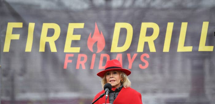 A photo of Jane in a red hat and red jacket speaking a Fire Drill Friday protest in D.C. in Jan. 2020