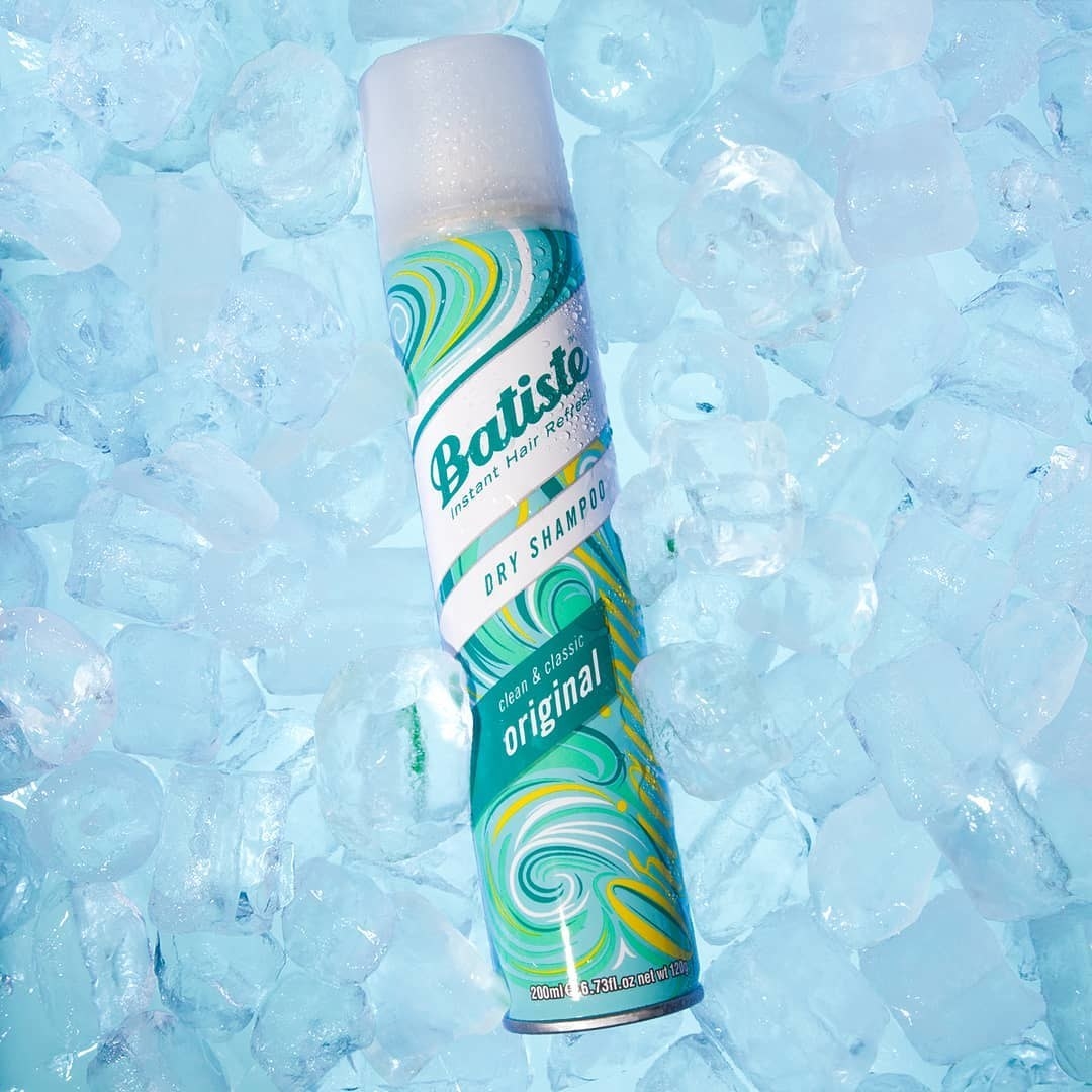A bottle of dry shampoo on a background of ice