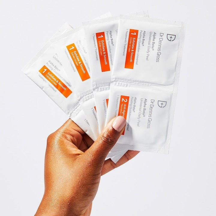 model holding up white and orange packs 