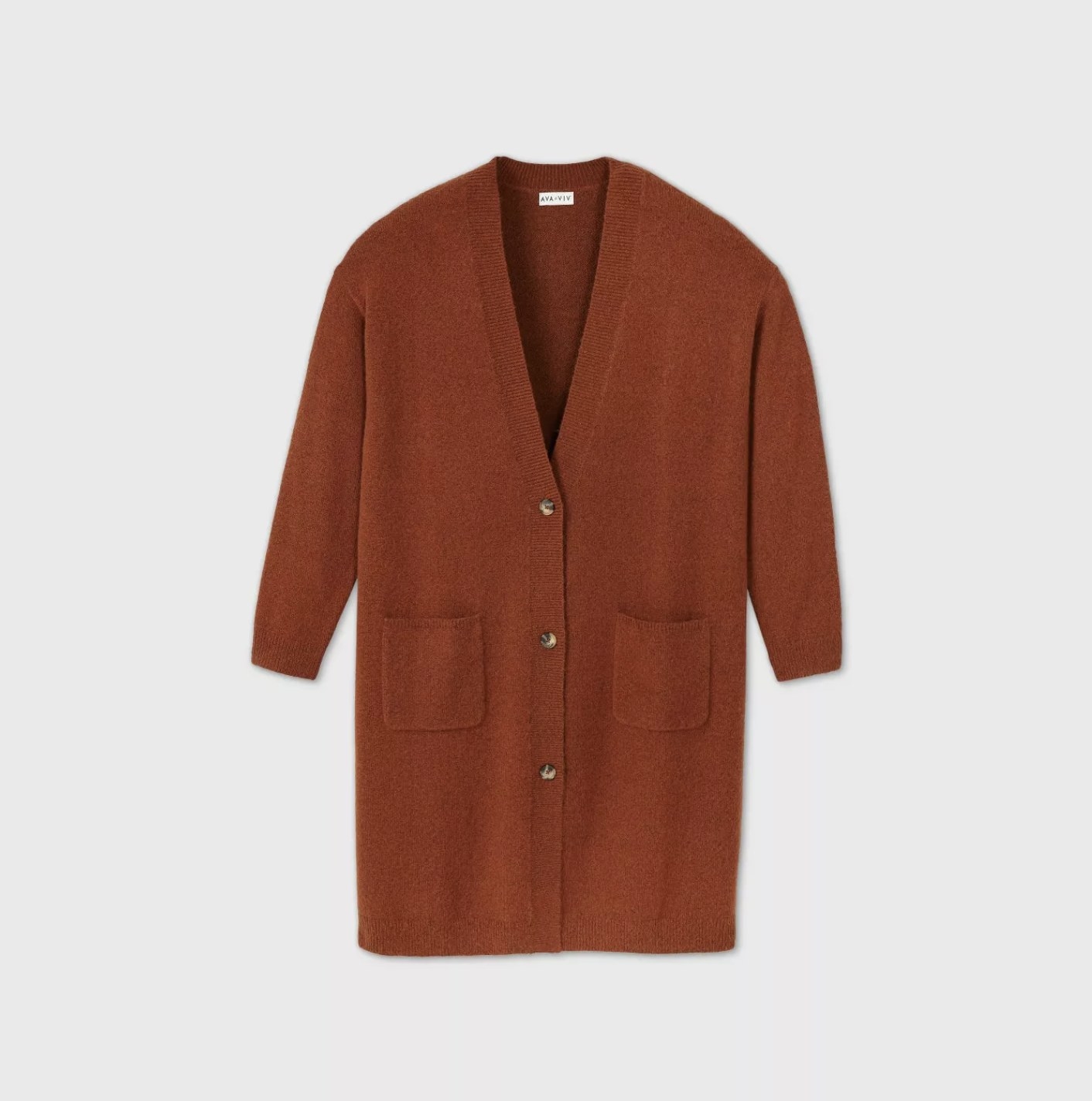 A burnt orange duster cardigan with a button front design and deep v-neckline