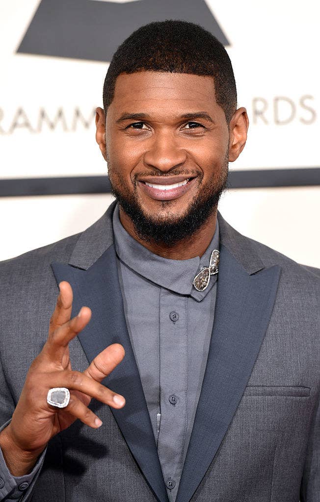 Usher smiling in a suit