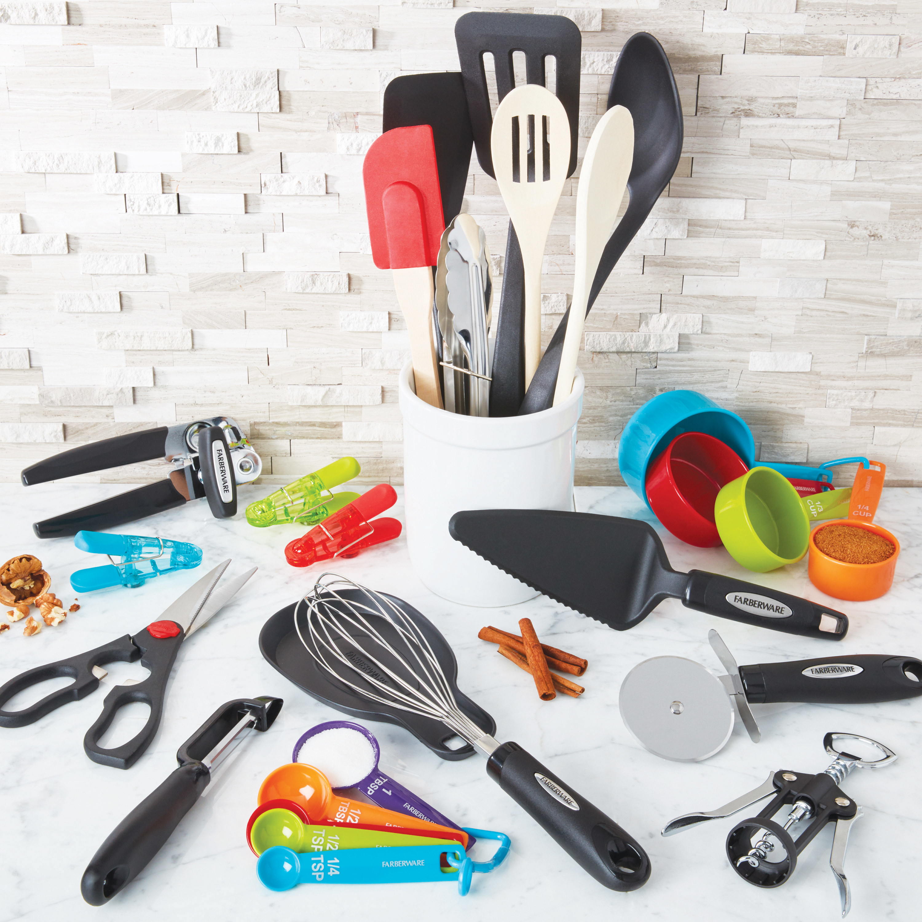 28 pieces of kitchen utensils and gadgets on a kitchen counter