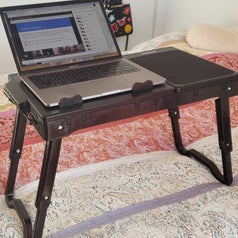 Same laptop tray. Yes, again. This time, it's legs are folded out even further so it's standing over a foot off of the bed. Yup. Extra tall baby.