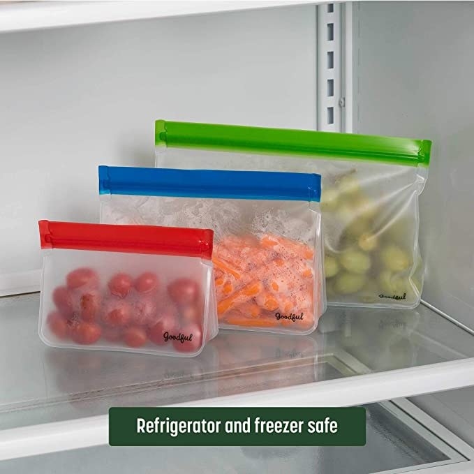 Three sizes of the Goodful reusable zipper locked bags in a fridge with a banner that reads &quot;refrigerator and freezer safe&quot;