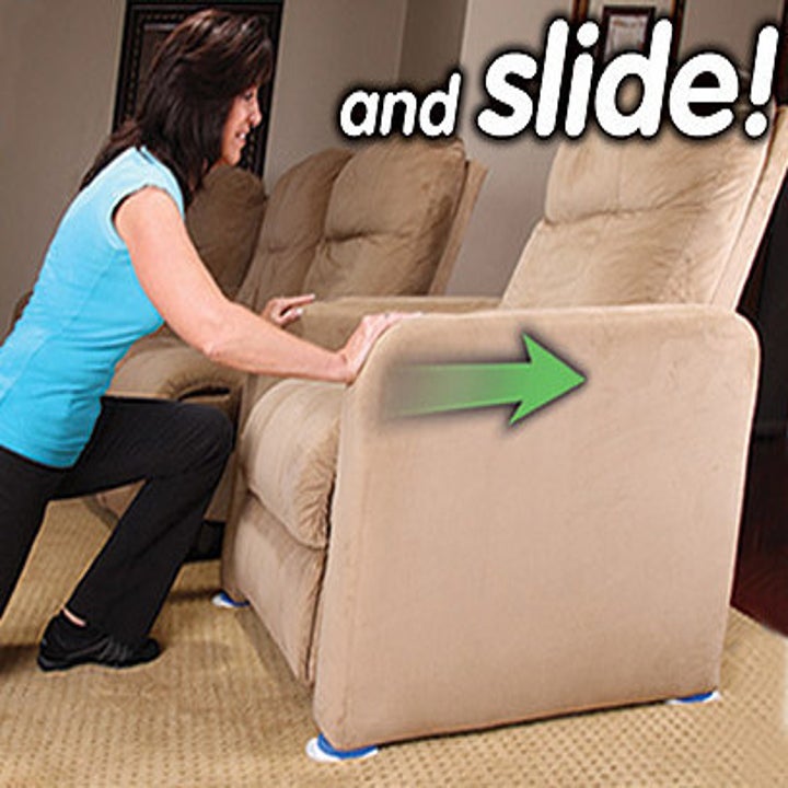 person sliding a large recliner with furniture gliders underneath