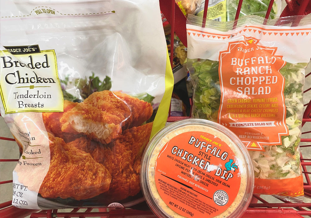 Breaded chicken tenders, buffalo style chicken dip, and buffalo ranch chopped salad in a shopping cart.