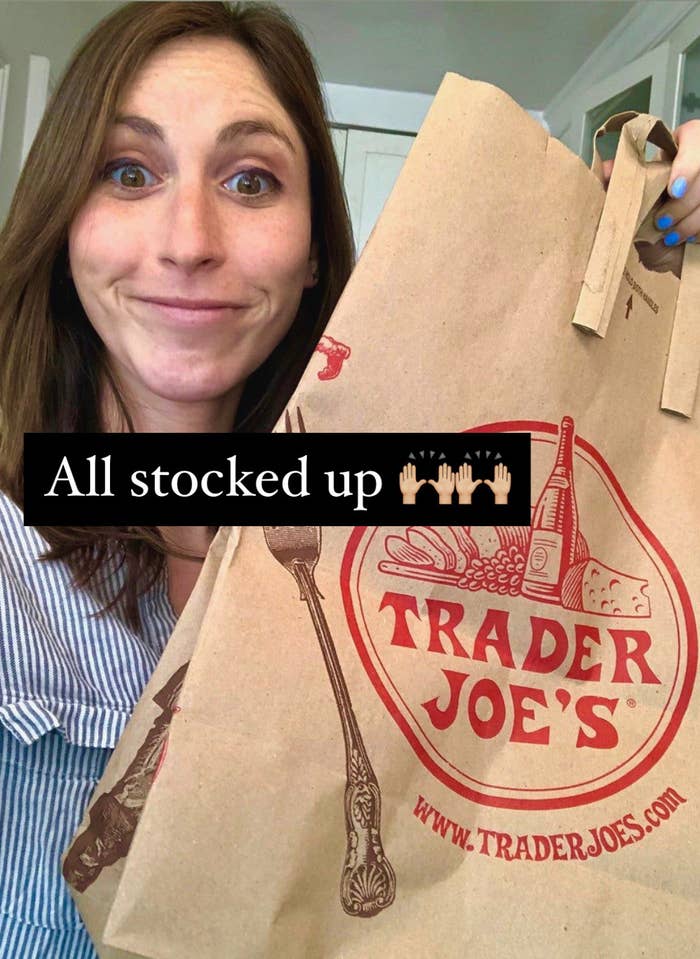 The author holding a Trader Joe&#x27;s bag after grocery shopping.