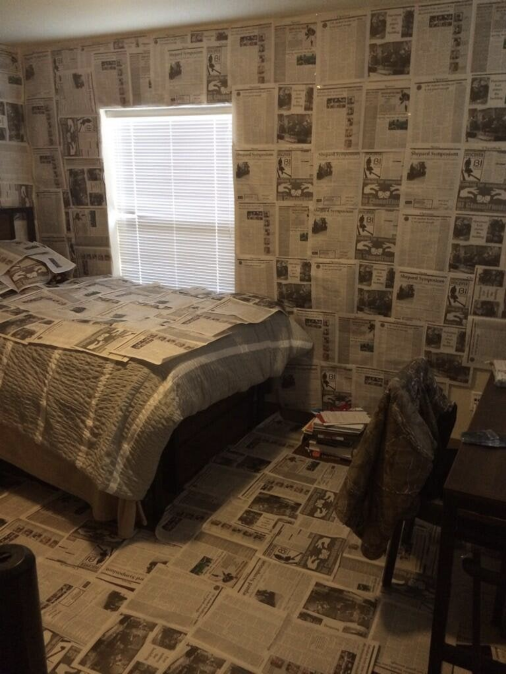 There is newspaper from floor to ceiling in the room