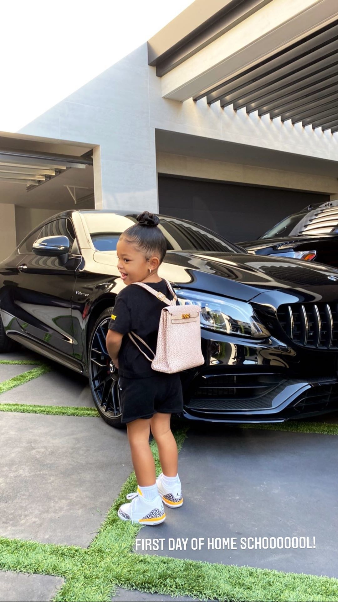 Stormi Webster wearing an Hermes backpack